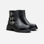 Flat ankle boots featuring cut-out detail with buckles